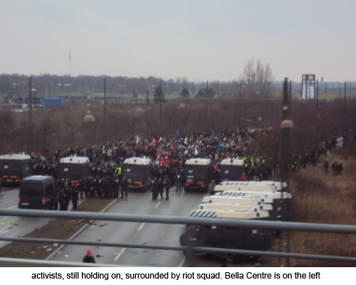 activists, still holding on, surrounded by riot squad. Bella Centre is on the left