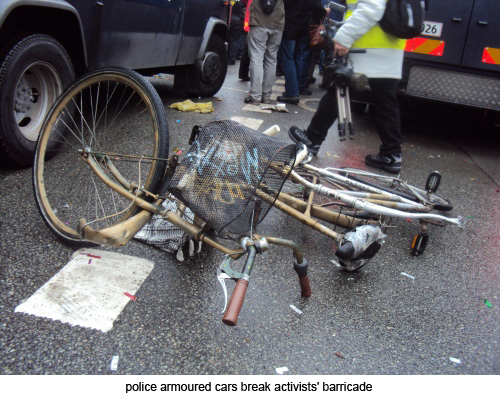 police armoured cars break activists' barricade